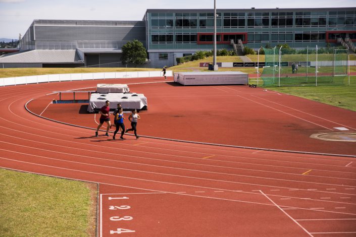 2 males and 2 females running as a group around the AUT Millennium outdoor track