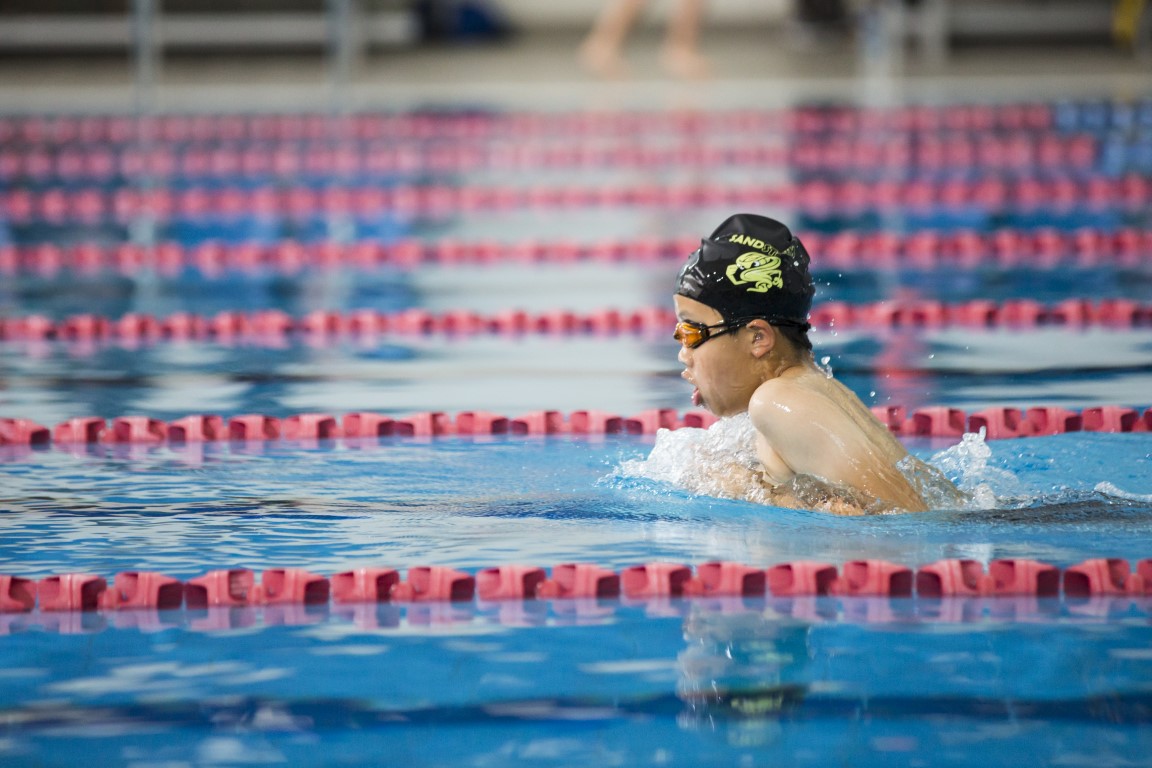 Young boy swimming in a race at AUT Millennium